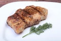 Grilled pork chop on plate on wooden board Royalty Free Stock Photo