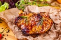 Grilled pork chop with spices and herbs on parchment paper Royalty Free Stock Photo