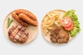 Grilled pork chop steak, sausage with french fries isolated on w Royalty Free Stock Photo