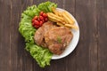 Grilled pork chop steak and vegetables with french fries on wood Royalty Free Stock Photo