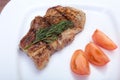 Grilled pork chop with vegetable on plate on wooden board Royalty Free Stock Photo