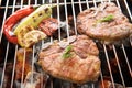 Grilled pork chop and vegetables on the flaming grill