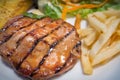 The grilled pork chops steak on white plate close up image Royalty Free Stock Photo