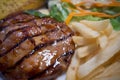 The grilled pork chops steak on white plate close up image Royalty Free Stock Photo