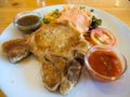 Grilled pork chops with vegetables, salad and dipping saurce Royalty Free Stock Photo