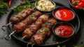 grilled pork kebab sticks on a black plate with different sauces Royalty Free Stock Photo
