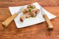 Grilled pork loin on bone on dish, fork and knife Royalty Free Stock Photo