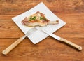 Grilled pork loin chop on dish with fork and knife Royalty Free Stock Photo