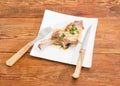 Grilled pork loin chop on dish with fork and knife Royalty Free Stock Photo