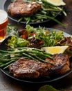 Grilled pork loin chops served with French green beans salad and beer Royalty Free Stock Photo