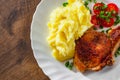 Grilled pork loin with mashed potatoes and salad in white plate on wooden table background with copy space. top view Royalty Free Stock Photo