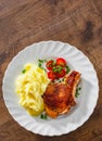 Grilled pork loin with mashed potatoes and salad in white plate on wooden table background with copy space. top view Royalty Free Stock Photo