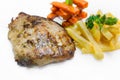 Grilled pork loin steaks, serve with french fries and vegetables Royalty Free Stock Photo