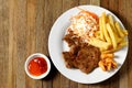 Grilled pork meat French fries and vegetables salad on plate,Top view Royalty Free Stock Photo