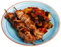 Grilled pork meat shashlik with sauteed vegetables