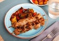 Grilled pork meat shashlik with sauteed vegetables