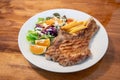 Grilled pork meat steak with oranges and vegetables Royalty Free Stock Photo