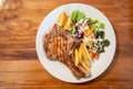 Grilled pork meat steak with oranges and vegetables Royalty Free Stock Photo