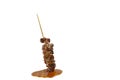 Grilled pork neck stabbing in wooden stick dressing spicy sauce on white background