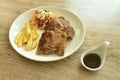 Grilled pork neck steak with french fries and salad dressing mayonnaise on plate dipping spicy sauce Royalty Free Stock Photo