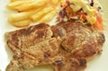 Grilled pork neck steak with french fries and salad dressing mayonnaise on plate dipping spicy sauce