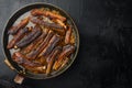 Grilled pork rib, in frying cast iron pan, on black stone background, top view flat lay, with copy space for text Royalty Free Stock Photo