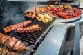 Grilled pork ribs with barbecue sauce on the grill. Vegetables, onion, chicken wings Royalty Free Stock Photo
