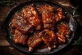Grilled pork ribs with barbecue sauce and thyme on wooden table.