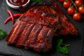 Grilled pork ribs with bbq sauce and herbs on stone board Royalty Free Stock Photo