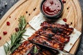 Grilled pork ribs BBQ served on wooden cutting board, banner, menu, recipe place for text, top view Royalty Free Stock Photo