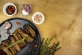 Grilled pork ribs on a black plate with spices and seasonings on a wooden table, top view, fried pork ribs, flat lay, copy space Royalty Free Stock Photo