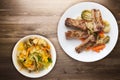 Grilled pork ribs with broccoli cabbage, carrots and garlic on a white plate. fried pork ribs with vegetables on a wooden Royalty Free Stock Photo