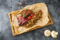 Grilled pork ribs, buckwheat with mushroom and tomatoes on cutting board. Close up Royalty Free Stock Photo