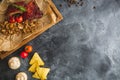 Grilled pork ribs, buckwheat with mushroom and tomatoes on old vintage wooden cutting board. Flat lay, top view. Copy space. Royalty Free Stock Photo