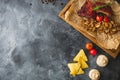 Grilled pork ribs, buckwheat with mushroom and tomatoes on vintage wooden cutting board on dark table. Flat lay, top view. Copy sp Royalty Free Stock Photo