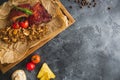 Grilled pork ribs, buckwheat with mushroom and tomatoes on vintage wooden cutting board. Flat lay, top view. Copy space. Royalty Free Stock Photo