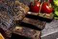 grilled pork ribs with french fries and vegetables on a wooden board Royalty Free Stock Photo