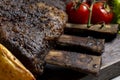 grilled pork ribs with french fries and vegetables on a wooden board Royalty Free Stock Photo