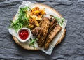 Grilled pork ribs and french fries on wooden board on grey background, top view. Delicious appetizers, tapas Royalty Free Stock Photo