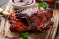 Grilled pork ribs with herbs on wooden board Royalty Free Stock Photo