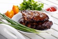 Grilled pork ribs. Meat bbq ribs served with sauce and fresh vegetables