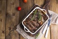 Grilled pork ribs. Meat with spices and herbs in dishes on wooden background. Lunch barbecue with salad and sauce. Free space for Royalty Free Stock Photo