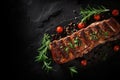 grilled pork ribs with rosemary and peppercorns on black background, grilled ribs with herbs and spices on Black background, copy