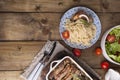 Grilled pork ribs and spaggeti. Meat with spices and herbs in dishes on wooden background. Lunch barbecue with salad and sauce. Royalty Free Stock Photo