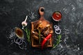 Grilled pork ribs with spices on black stone background. Royalty Free Stock Photo