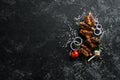 Grilled pork ribs with spices on black stone background. Royalty Free Stock Photo