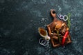 Grilled pork ribs with spices on black stone background. Royalty Free Stock Photo