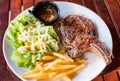 Grilled pork ribs steak well-done with french fries and vegetable Royalty Free Stock Photo