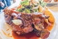 Grilled pork ribs on white plate decorated with salad and fried potato Royalty Free Stock Photo