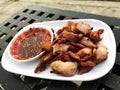 Grilled pork with spicy source on Black wooden table